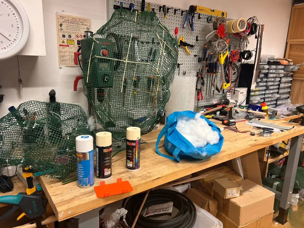 Cloud armatures, electronics and fabrication materials on a workshop bench