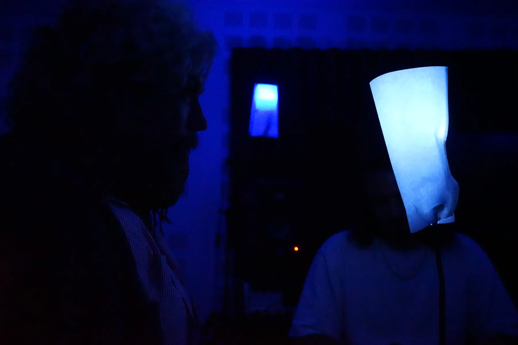 A player in silhouette within deep blue night-time lighting