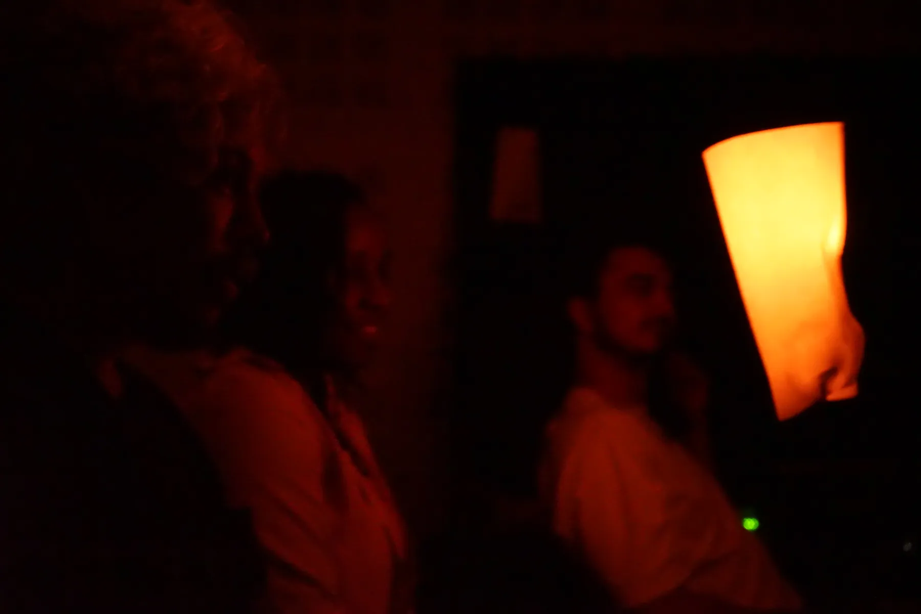 Players around a table illuminated by a warm simulated candlelight ambience