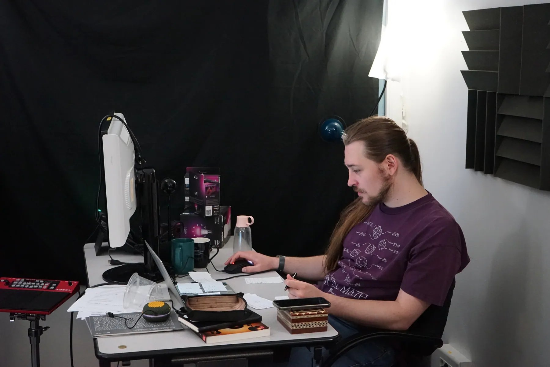 Guillaume preparing the tabletop role-playing session in a room surrounded by lights